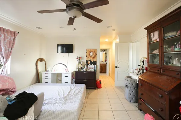 a bedroom with a bed dresser and a window
