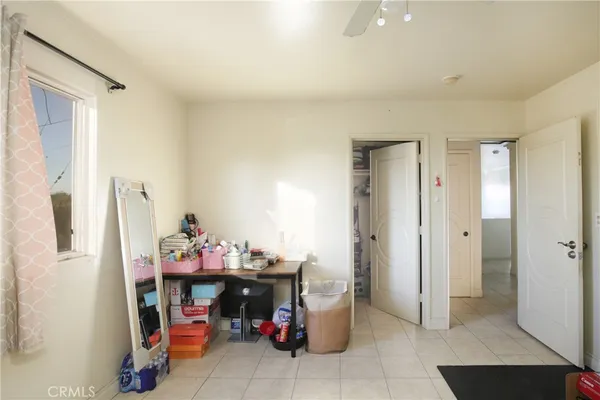 a bedroom with furniture and a window