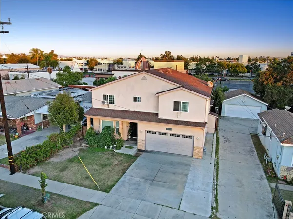 an aerial view of a house with a yard