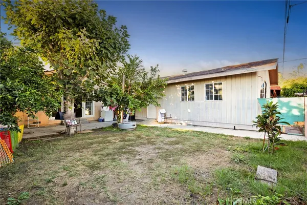 a backyard of a house with table and chairs