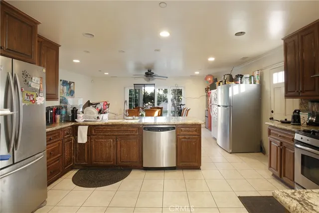 a kitchen with refrigerator and cabinets