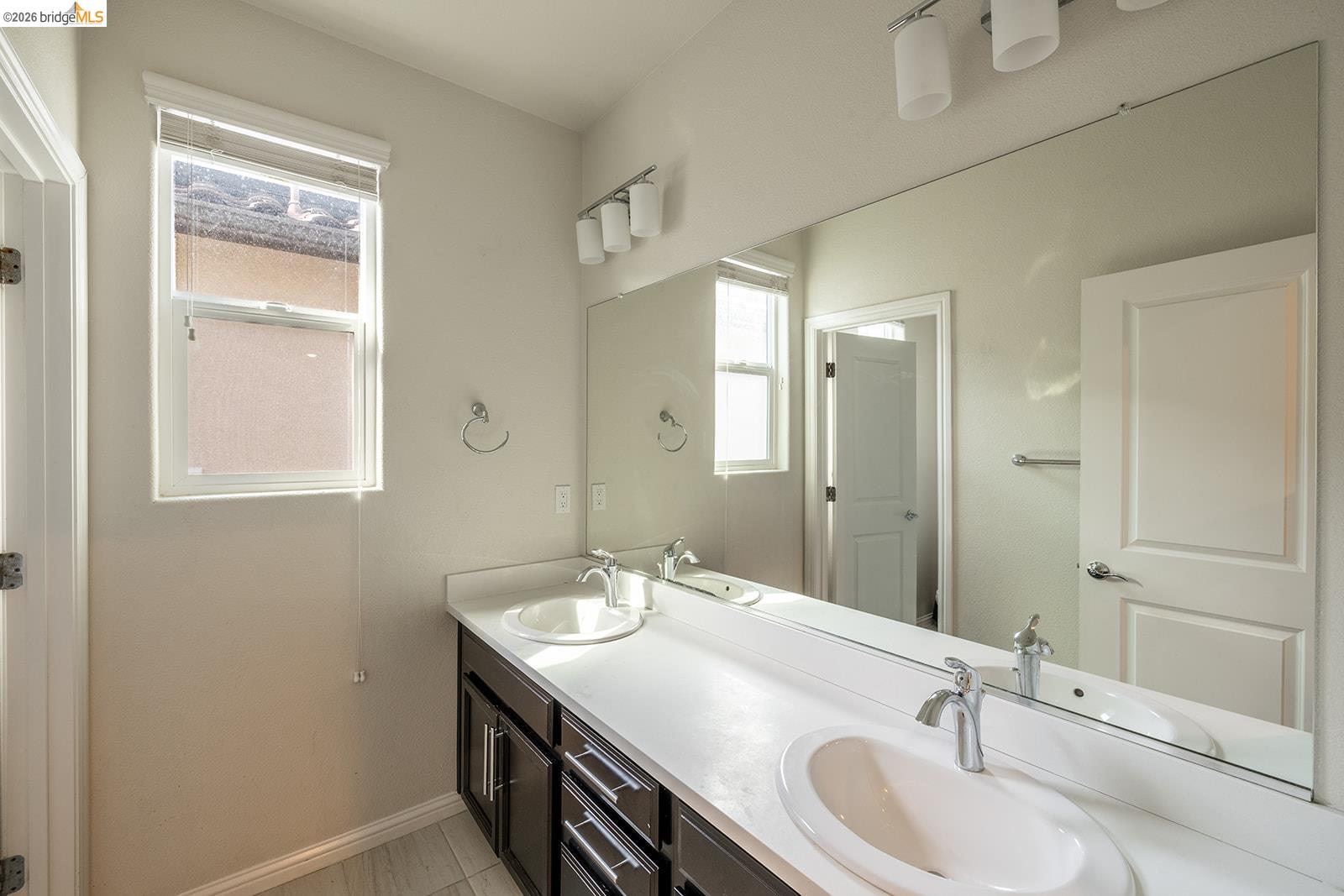 974 Princess Way Brentwood, CA 94513 - Photo 35 of 49 Bathroom featuring a dual vanity with white countertops, undermount sinks, chrome faucets, and dark wood-finish cabinetry