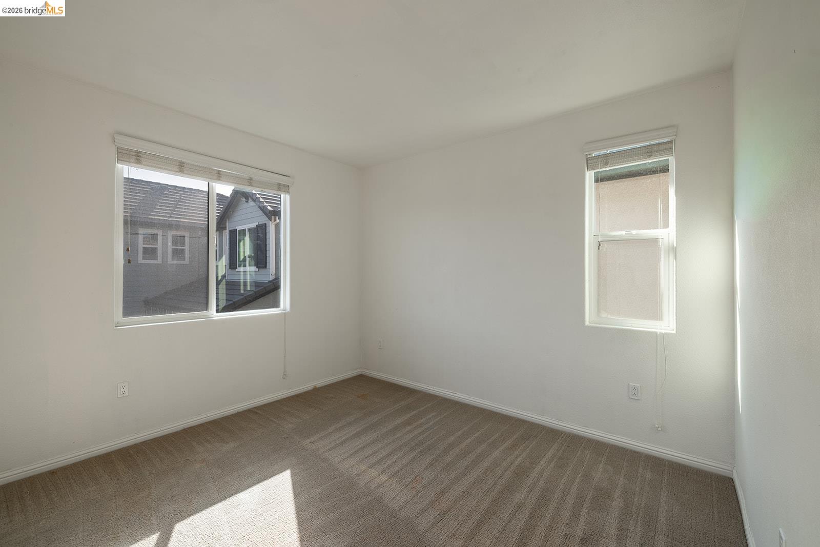 974 Princess Way Brentwood, CA 94513 - Photo 37 of 49 Neutral-toned carpet flooring, white painted walls, and two windows with blinds