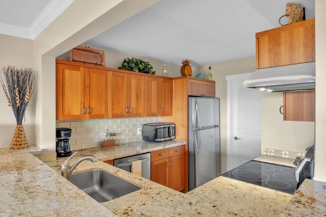 a kitchen with a refrigerator and a sink