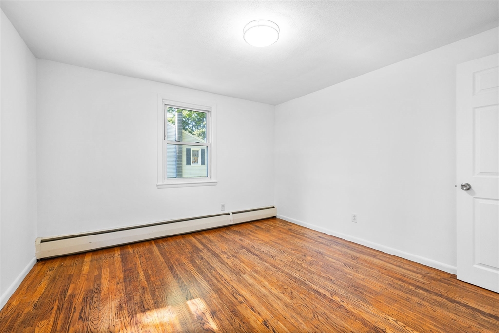 18 Pullard Road Grafton, MA 01519 - Photo 16 of 28 an empty room with wooden floor and windows