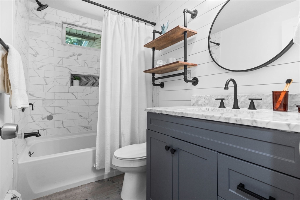 18 Pullard Road Grafton, MA 01519 - Photo 18 of 28 a bathroom with a granite countertop sink a toilet and shower