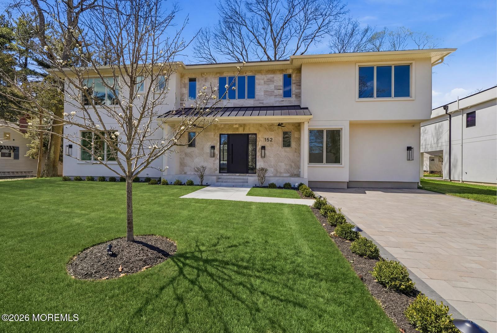 152 Ampere Avenue Oakhurst, NJ 07755 - Photo 1 of 18 a front view of a house with a yard