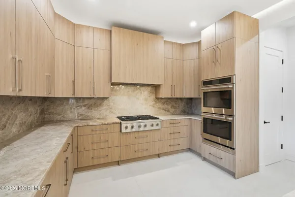 a kitchen with stainless steel appliances granite countertop a stove and a refrigerator