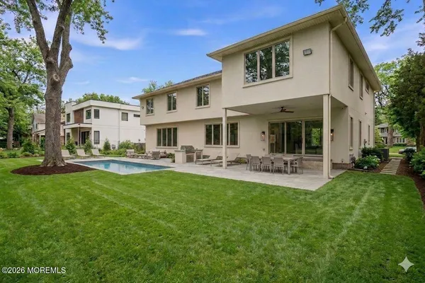 a front view of a house with swimming pool yard and patio