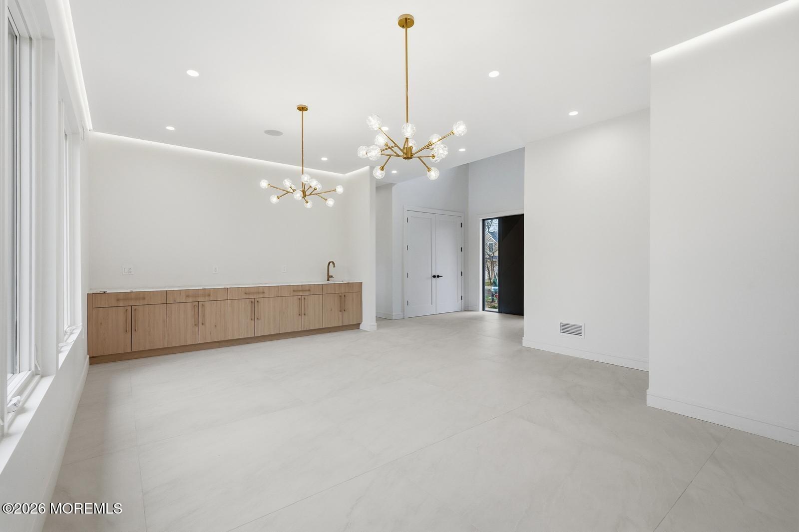 152 Ampere Avenue Oakhurst, NJ 07755 - Photo 6 of 18 a view of a livingroom with a chandelier fan and kitchen view