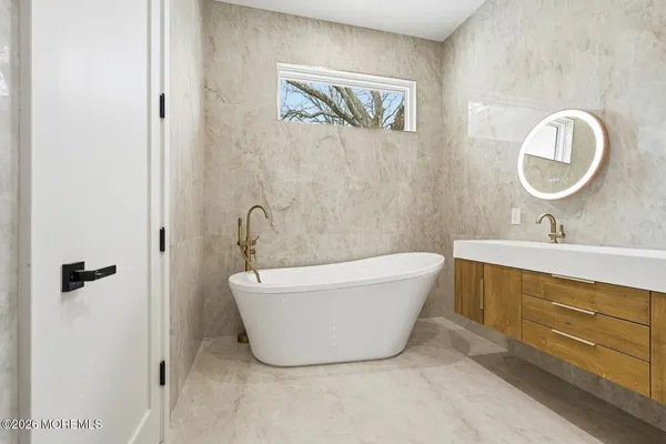 a bathroom with a bathtub and a sink