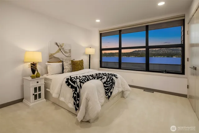 a bedroom with a large bed and a balcony view