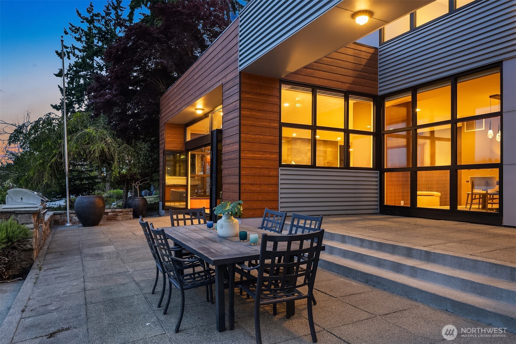 3840 East Mercer Way Mercer Island, WA 98040 - Photo 36 of 40 a view of a patio with a table and chairs and potted plants