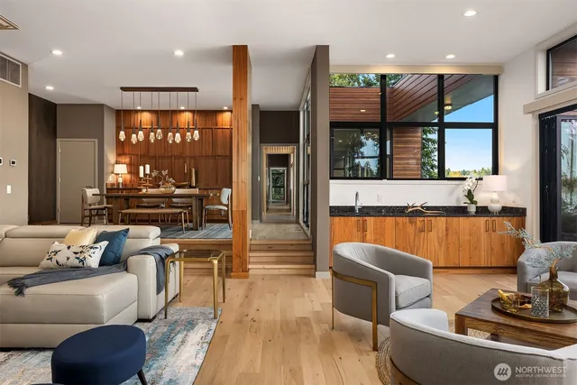 a living room with furniture and large windows