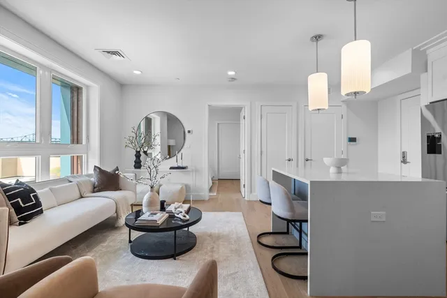 a living room with furniture and a chandelier