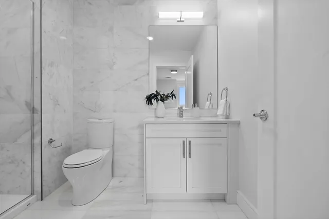 a bathroom with a sink toilet and a mirror