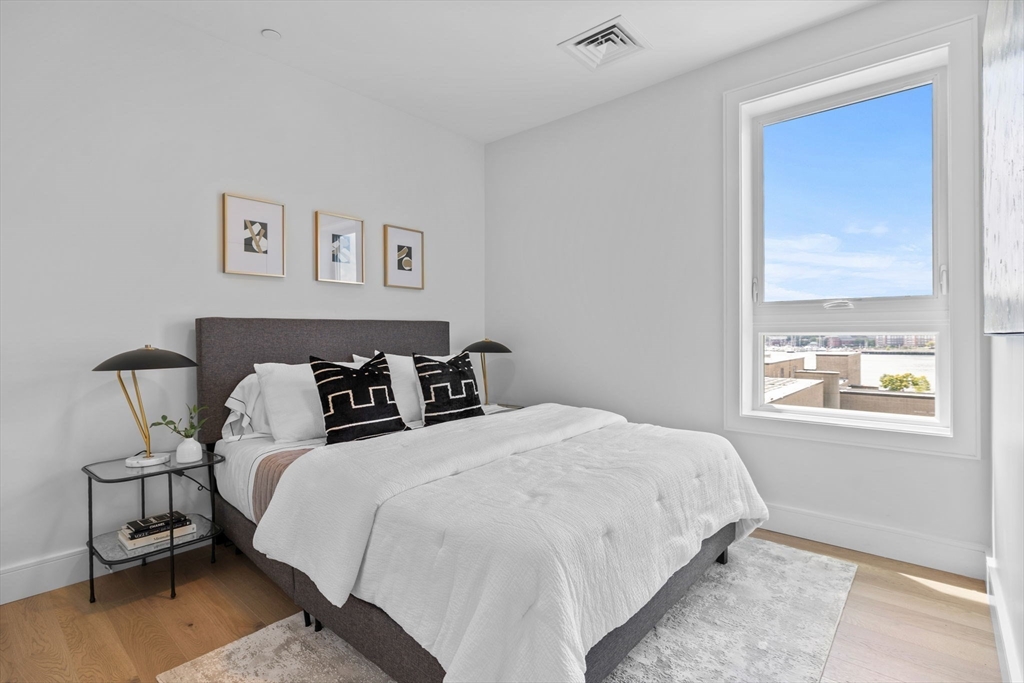 301 Border Street, Unit 409 Boston, MA 02128 - Photo 15 of 23 a bedroom with bed and a window