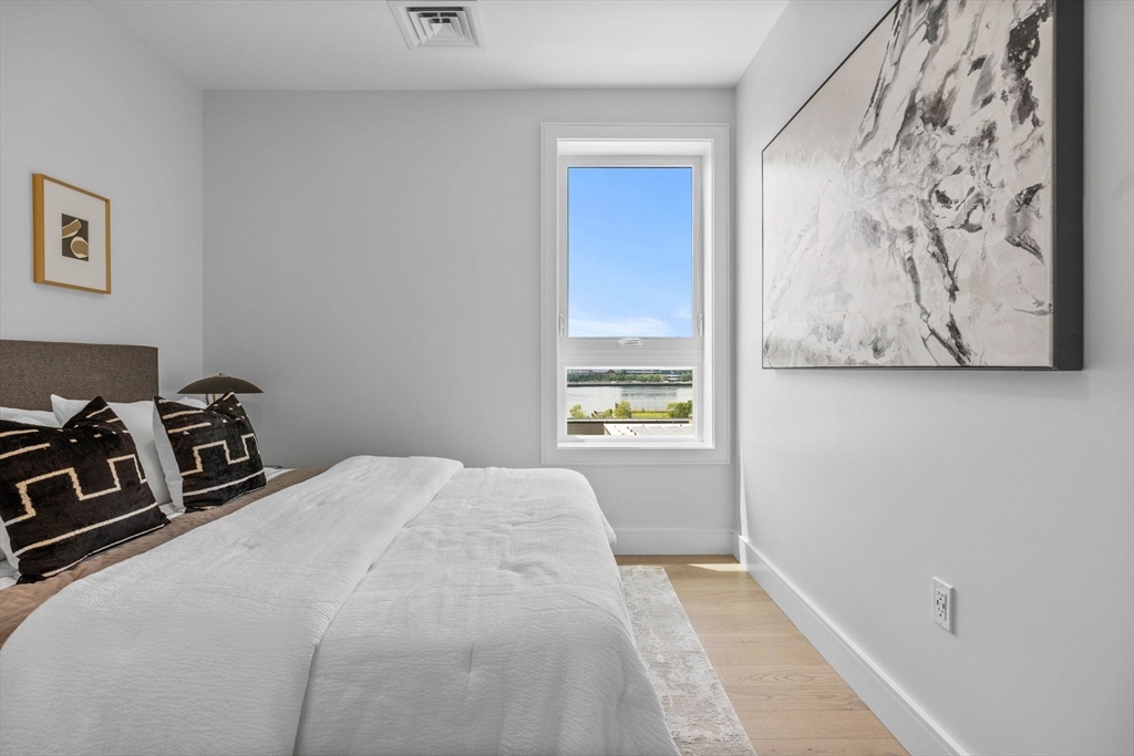 301 Border Street, Unit 409 Boston, MA 02128 - Photo 16 of 23 a bedroom with a bed and a window