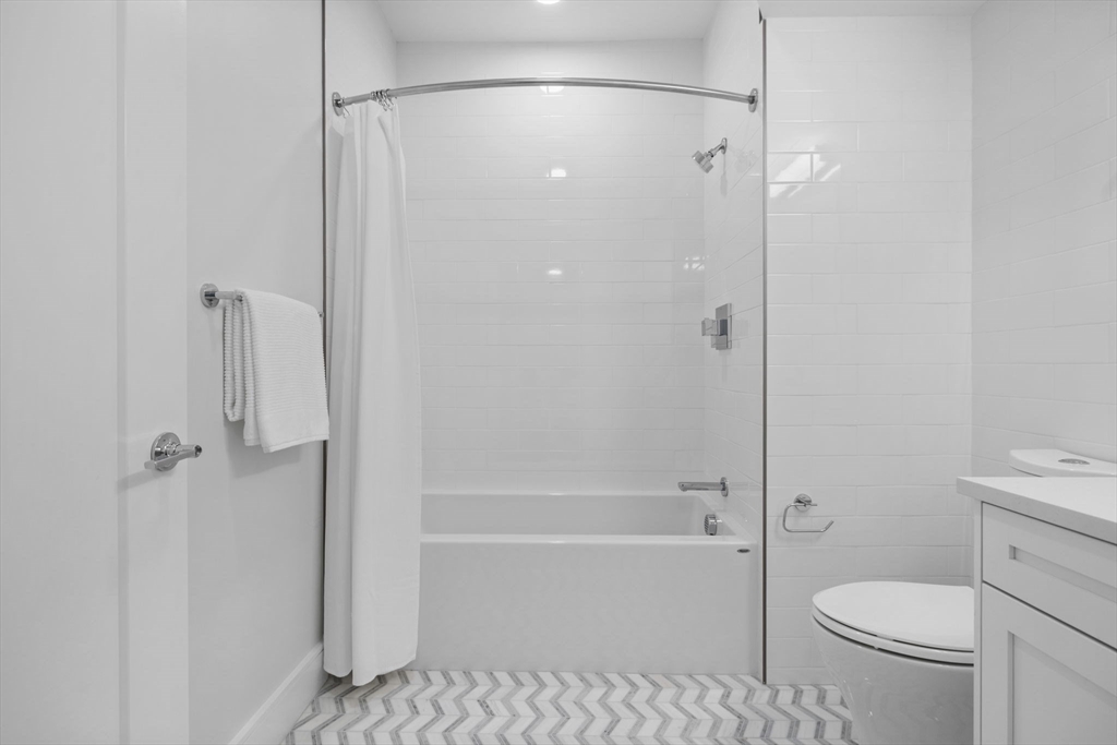 301 Border Street, Unit 409 Boston, MA 02128 - Photo 18 of 23 a bathroom with a shower a toilet and a shower