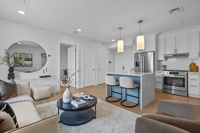 a living room with furniture and a kitchen
