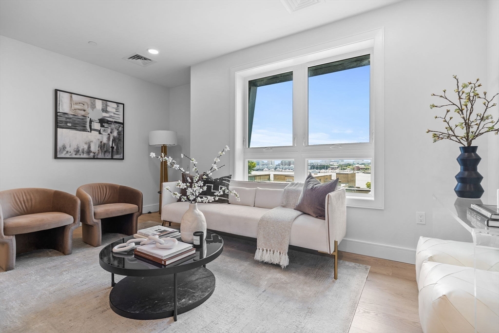 301 Border Street, Unit 409 Boston, MA 02128 - Photo 7 of 23 a living room with furniture or couch and a potted plant