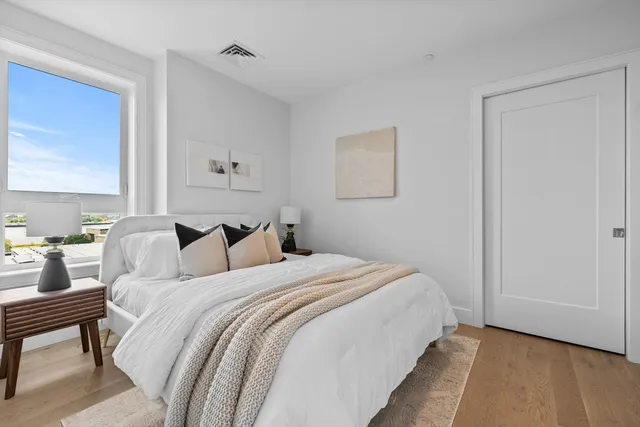 a bedroom with bed and a window