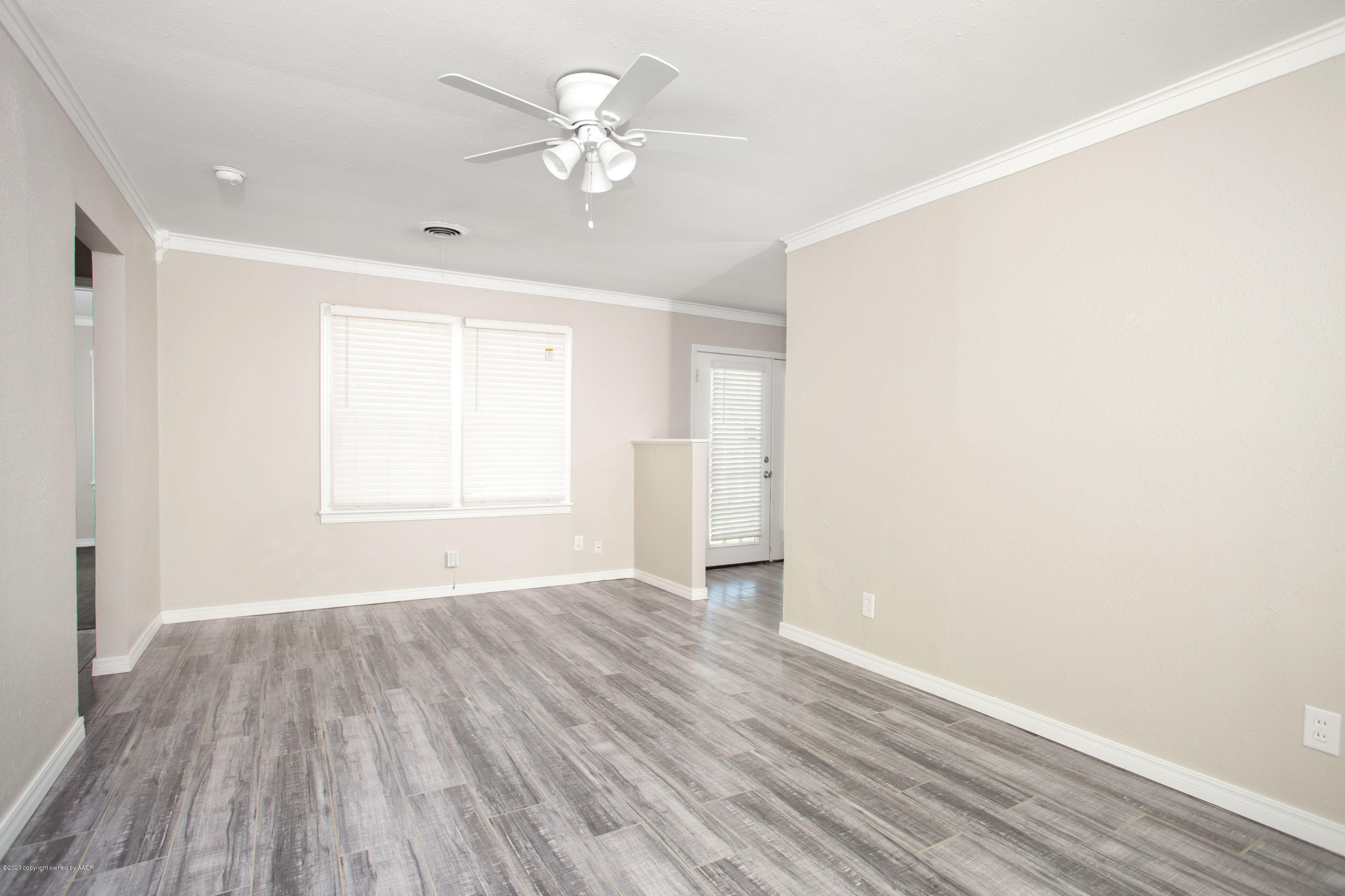 3616 Cline Road Amarillo, TX 79110 - Photo 6 of 29 wooden floor in an empty room with a window