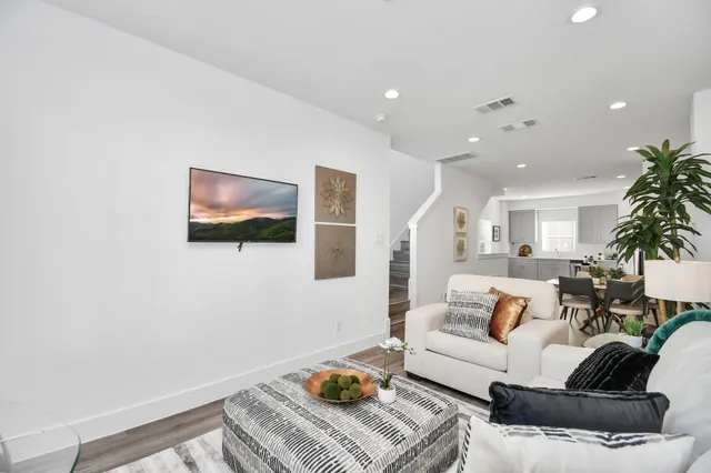 a living room with furniture and a potted plant