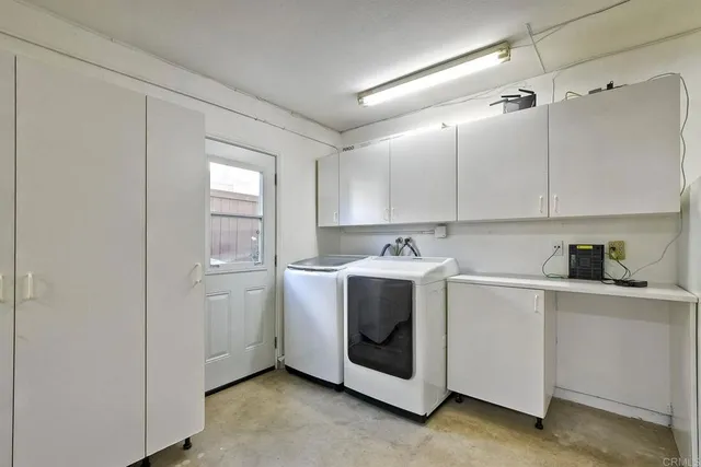 a utility room with sink dryer and washer