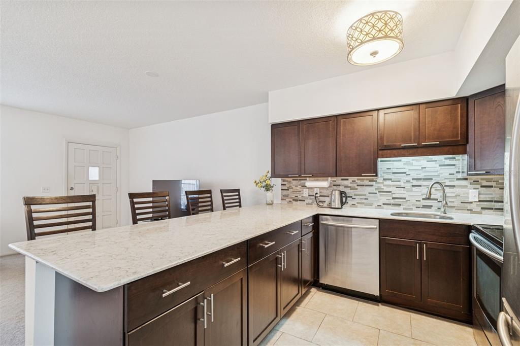 2295 Mexican Way, Unit 21 Clearwater, FL 33763 - Photo 14 of 90 a kitchen with stainless steel appliances a sink stove and cabinets