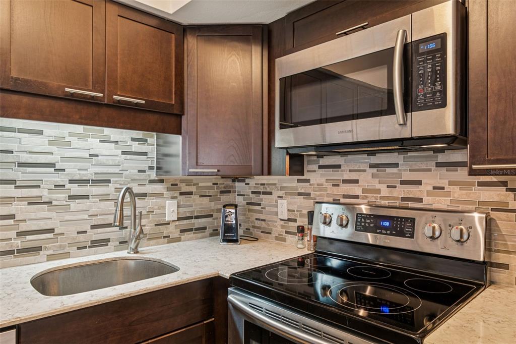 2295 Mexican Way, Unit 21 Clearwater, FL 33763 - Photo 15 of 90 a kitchen with a stove and a sink