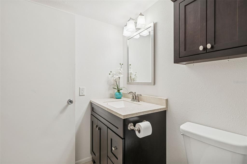 2295 Mexican Way, Unit 21 Clearwater, FL 33763 - Photo 19 of 90 a bathroom with a sink a toilet and mirror