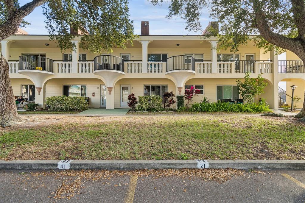 2295 Mexican Way, Unit 21 Clearwater, FL 33763 - Photo 2 of 90 a front view of a residential houses with yard