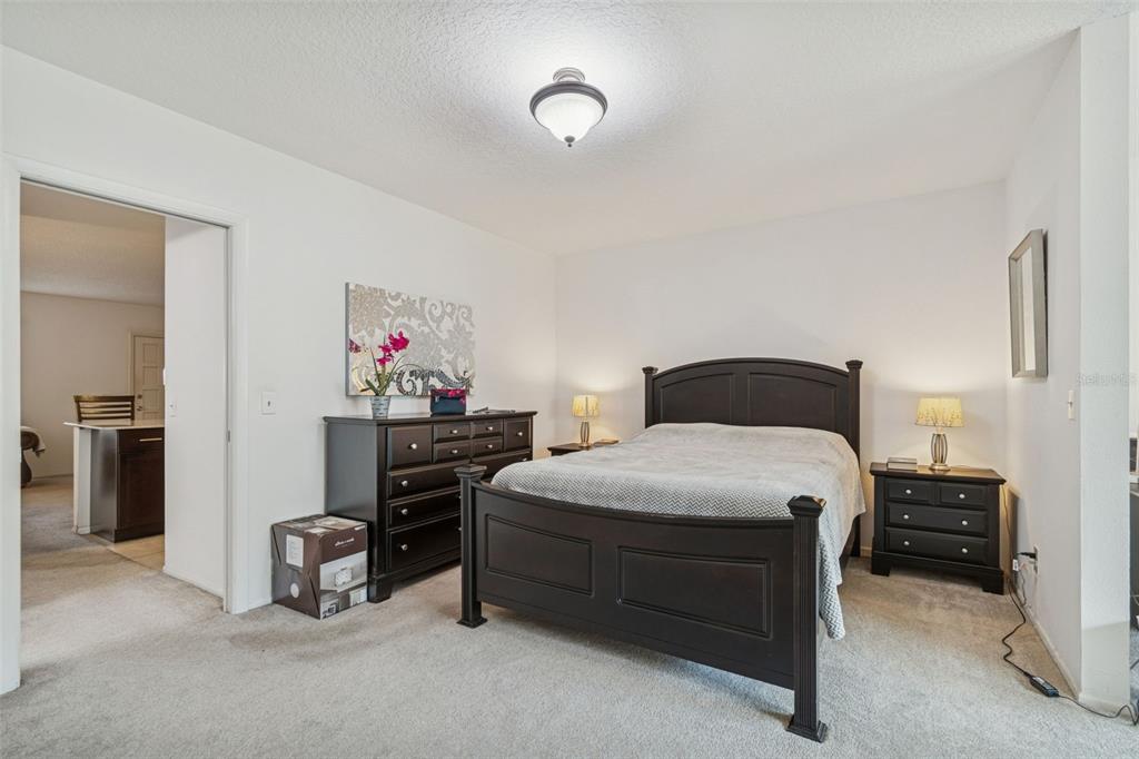 2295 Mexican Way, Unit 21 Clearwater, FL 33763 - Photo 22 of 90 a bedroom with a bed and a chandelier