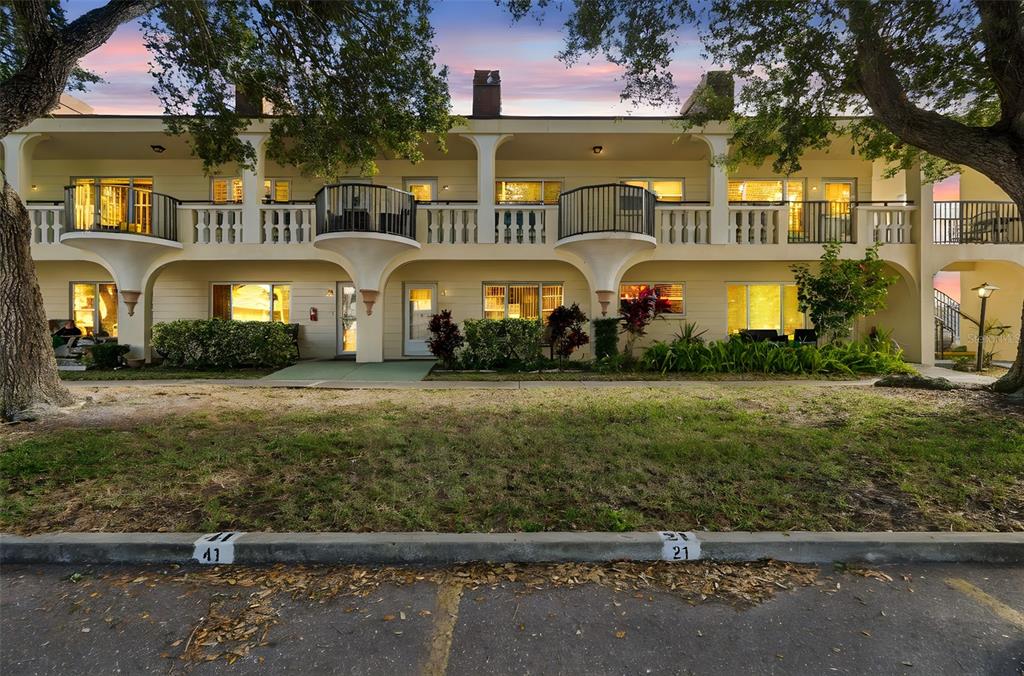 2295 Mexican Way, Unit 21 Clearwater, FL 33763 - Photo 3 of 90 a front view of a residential apartment building with a yard