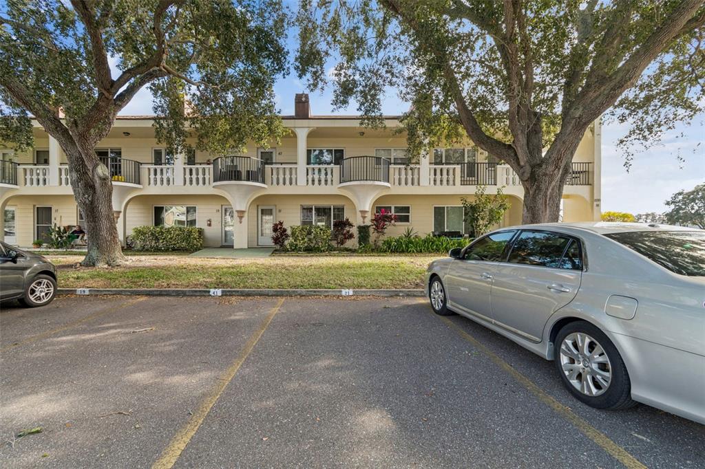 2295 Mexican Way, Unit 21 Clearwater, FL 33763 - Photo 32 of 90 a car parked in front of a white house