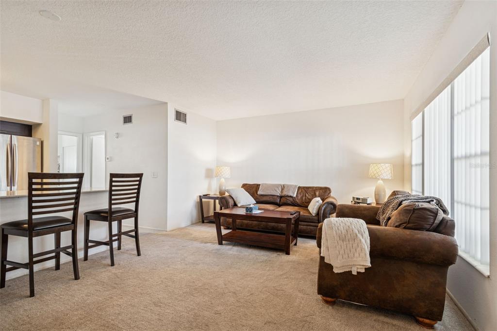 2295 Mexican Way, Unit 21 Clearwater, FL 33763 - Photo 7 of 90 a living room with furniture and a large window