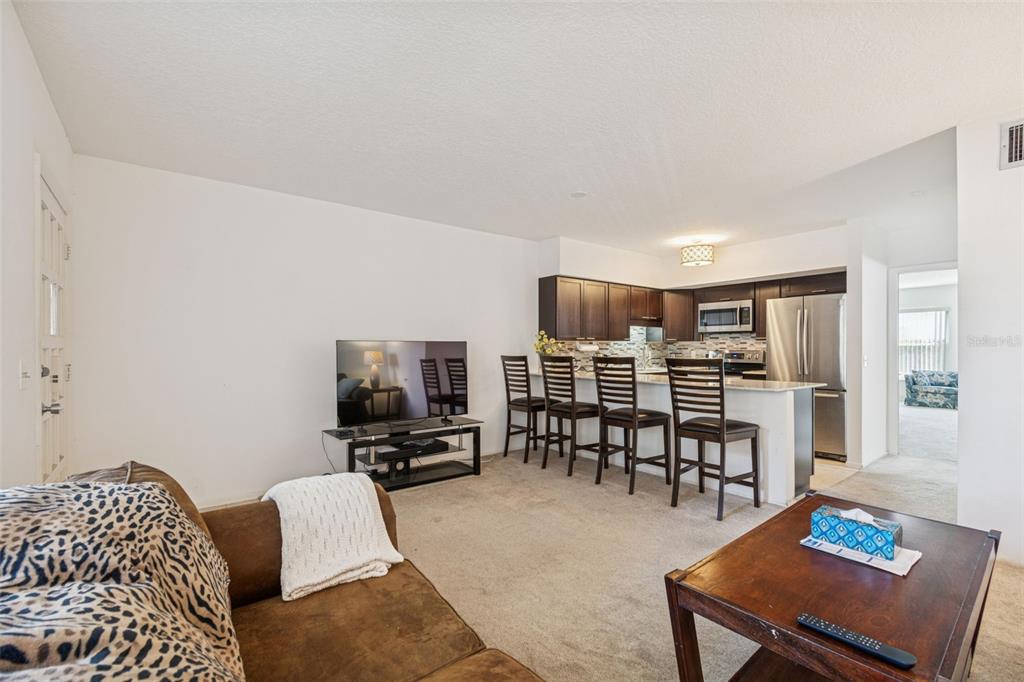 2295 Mexican Way, Unit 21 Clearwater, FL 33763 - Photo 10 of 90 a living room with furniture and a flat screen tv