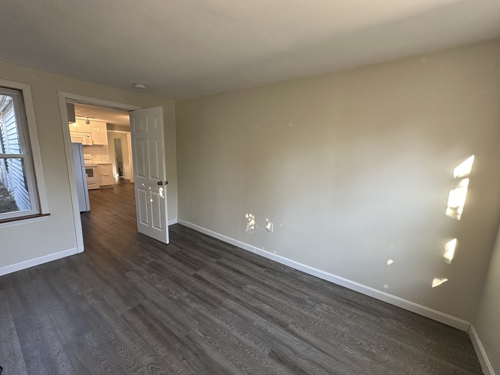 8 Pike Street Hopkinton, MA 01748 - Photo 22 of 34 a view of an empty room with wooden floor and a window