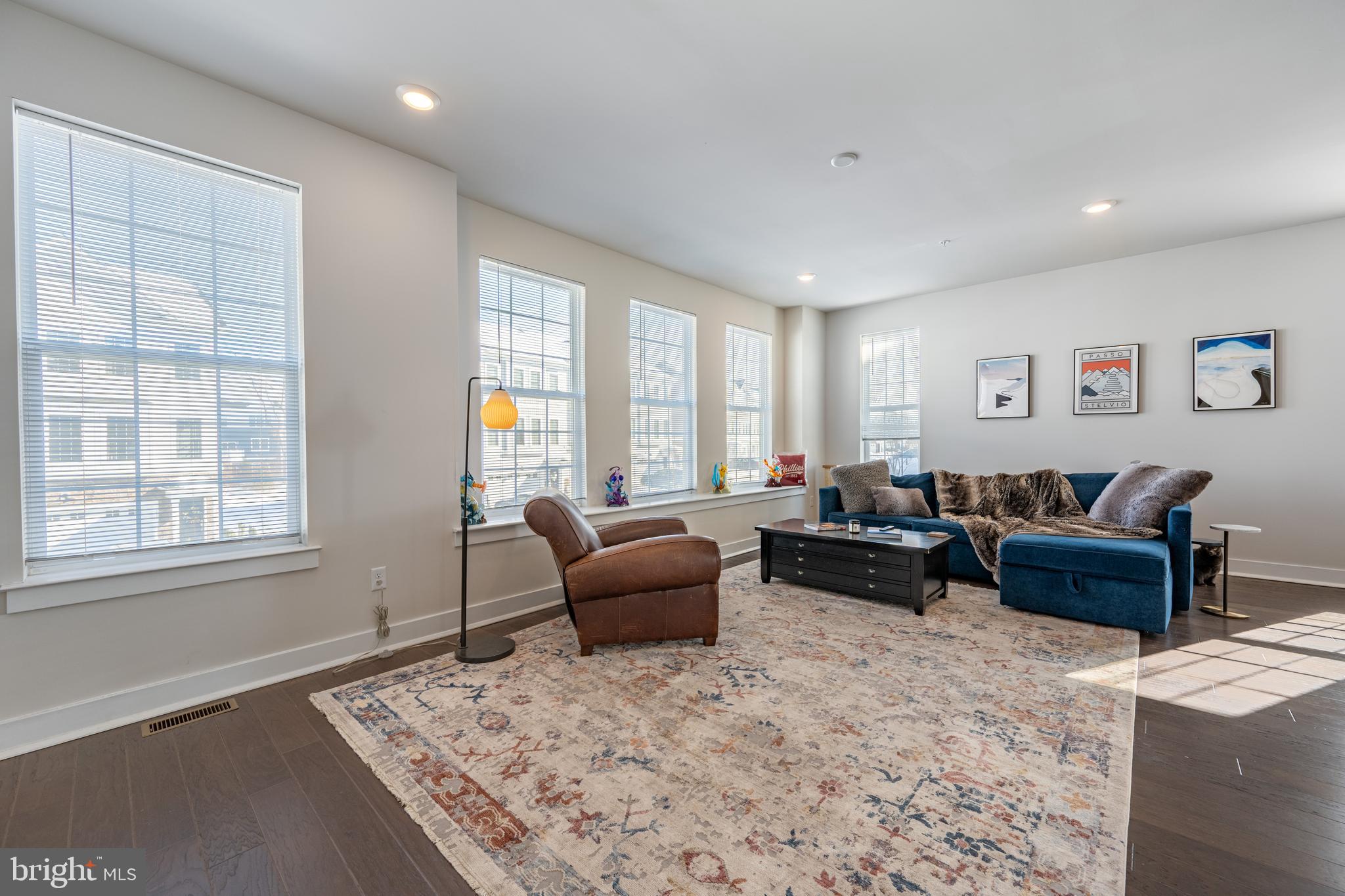 a living room with furniture windows and a flat screen tv