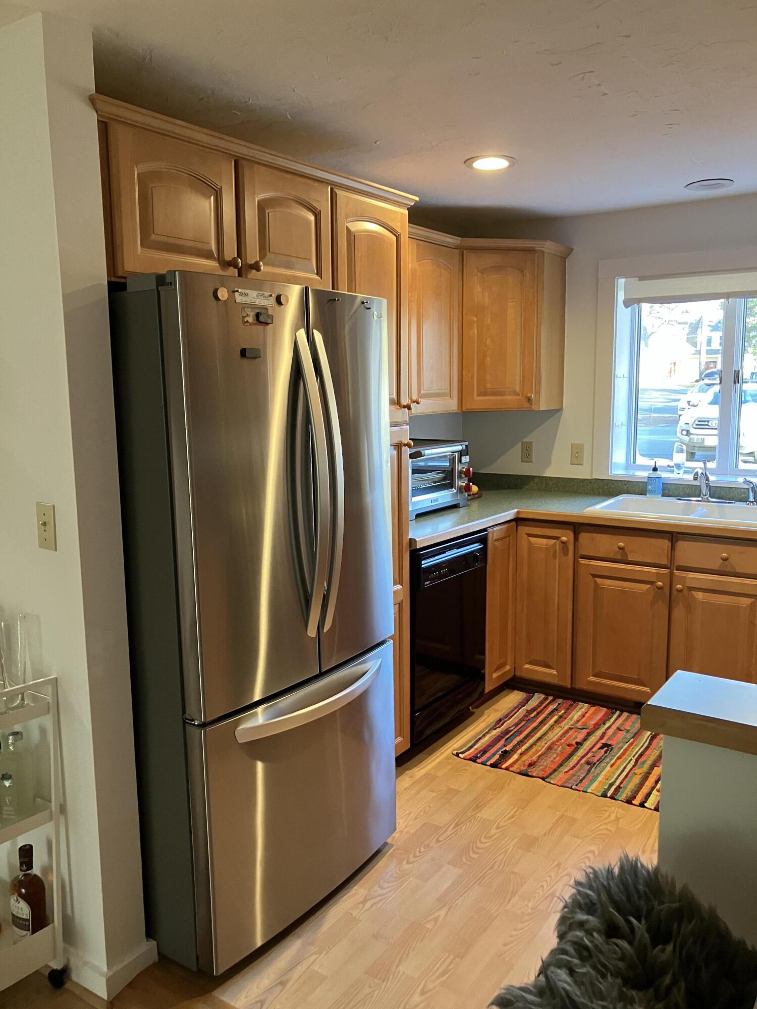 40 Shellback Way, Unit F Mashpee, MA 02649 - Photo 2 of 29 a kitchen with stainless steel appliances granite countertop a refrigerator a sink dishwasher a stove with cabinets and wooden floor
