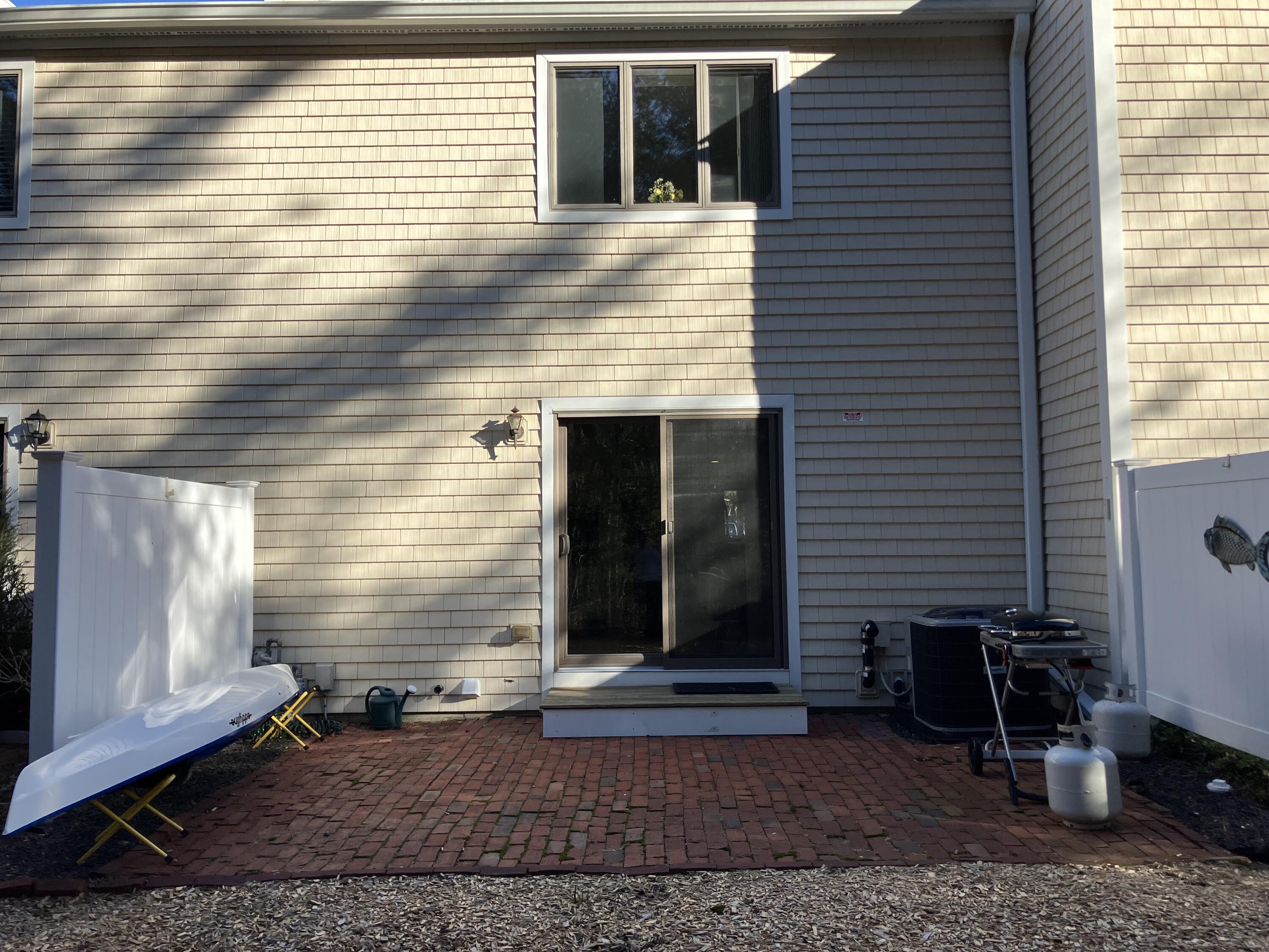 40 Shellback Way, Unit F Mashpee, MA 02649 - Photo 29 of 29 a view of house with backyard space and wooden door