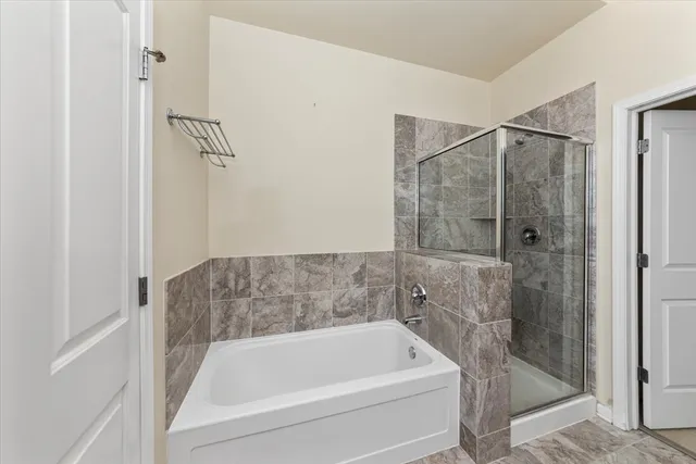 a bathroom with a bath tub and shower
