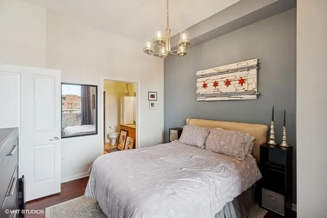 a bedroom with a bed and a chandelier