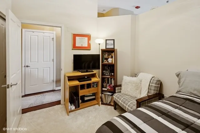 a bedroom with furniture and a flat screen tv