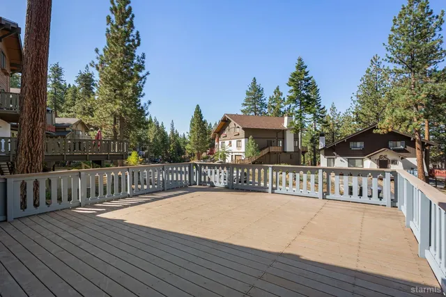 a view of a balcony with wooden floor and fence