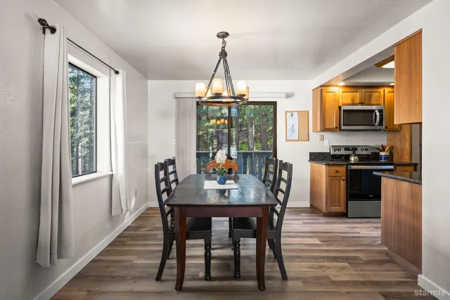 a dining room with furniture window and wooden floor
