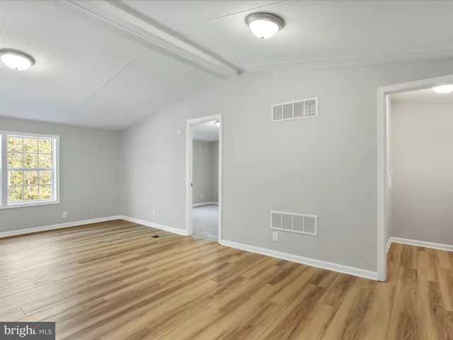 a kitchen with cabinets stainless steel appliances and a counter space