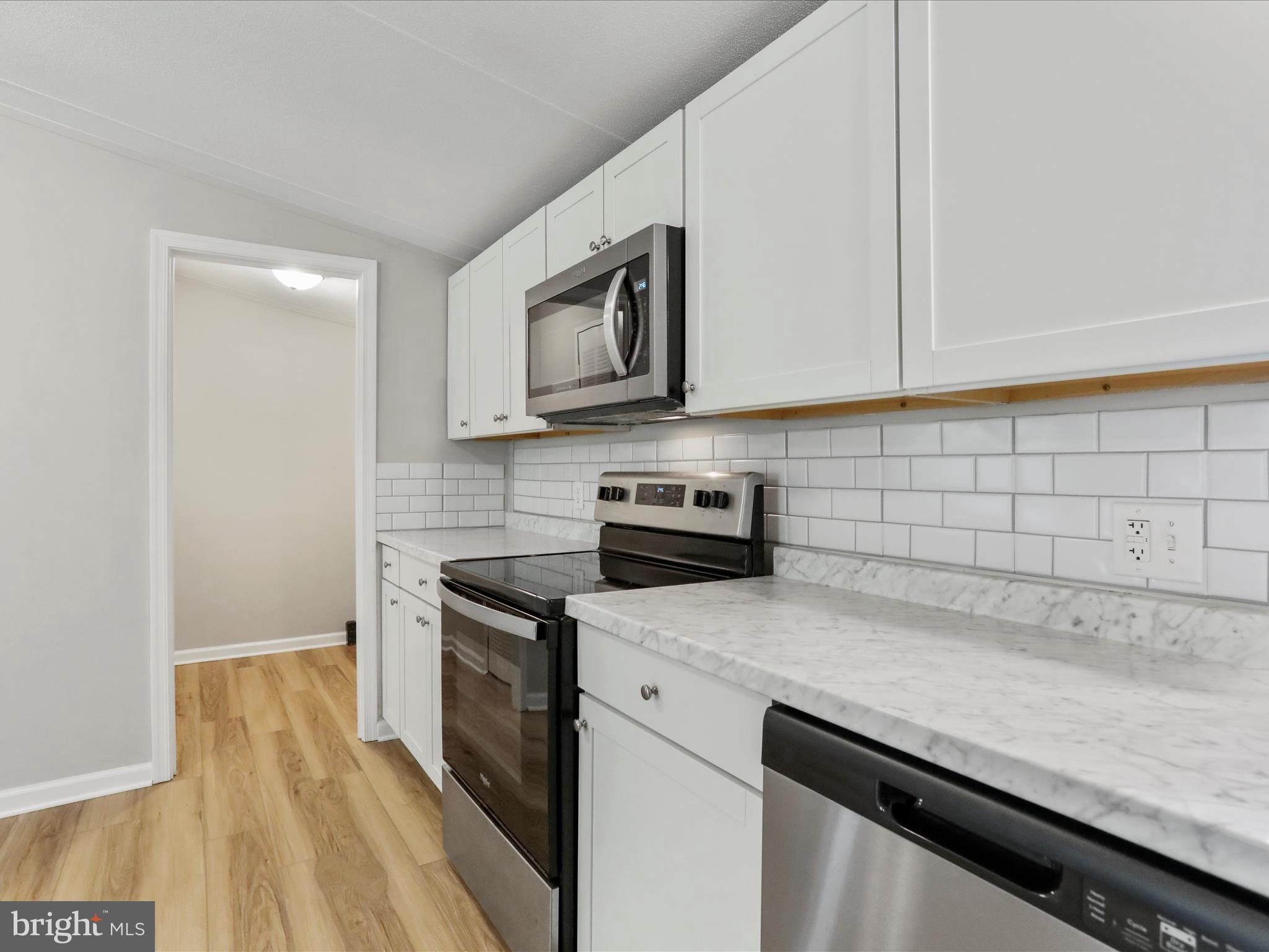 156 Potomacview Lane Berkeley Springs, WV 25411 - Photo 14 of 27 a kitchen with cabinets stainless steel appliances and a counter space
