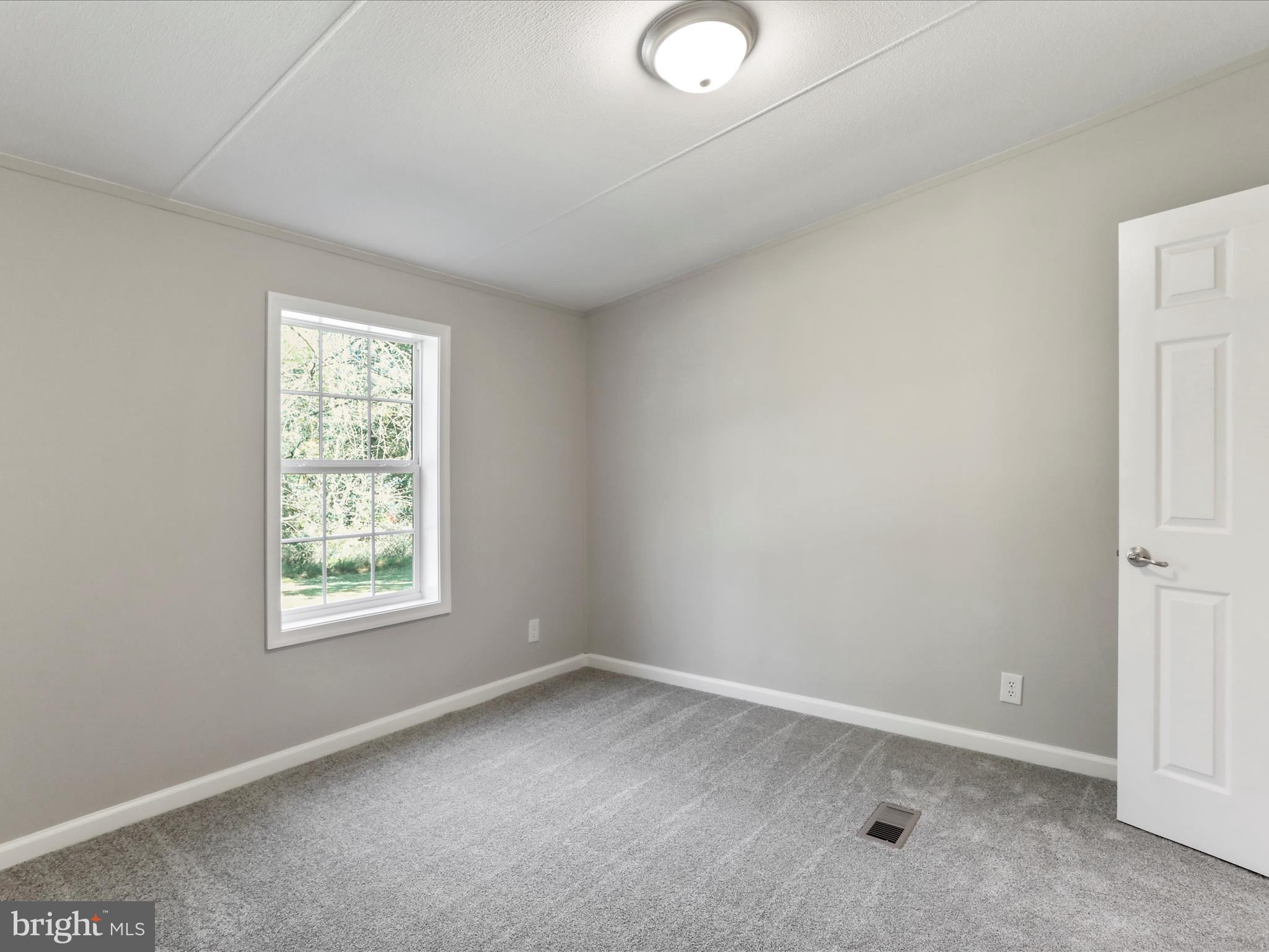 156 Potomacview Lane Berkeley Springs, WV 25411 - Photo 17 of 27 an empty room with a window